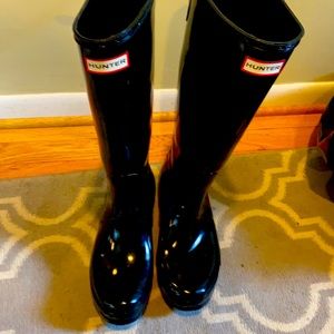 Tall glossy black hunter boots